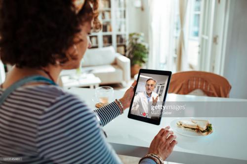 Close up of a pregnant lady talking to her doctor on a video call